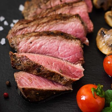 Juicy steak medium rare beef with spices and grilled vegetables.