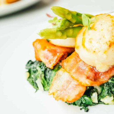 Grilled Scallops shell with bacon and asparagus vegetable in white plate